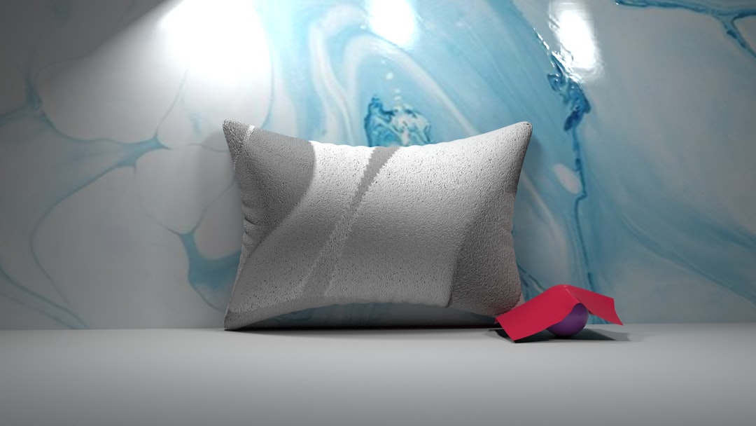 Close-up of an inflatable camping pillow showing the valve mechanism and fabric cover